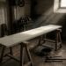 A long blank signboard, freshly primed and unlettered, lying across trestles in a dim workshop with a tin of black paint and unused brushes on the floor beside it.