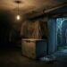 A backstage museum storage room at night: a humming chest freezer under a bare bulb, dust-sheeted shapes on shelving, and a drip tray catching condensation, while through an open door an overgrown eighteenth-century garden hermitage stands empty, its rough robe hanging on a peg.